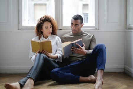 man-and-woman-sitting-on-the-floor-reading-book-3967013 man-and-woman-sitting-on-the-floor-reading-book-3967013